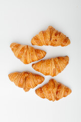 Top view of French delicious croissants on a light background