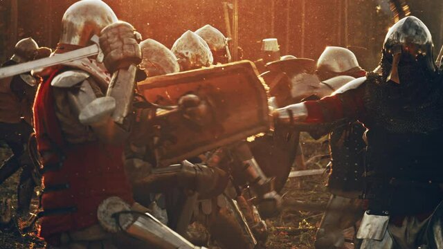 Epic Armies of Medieval Knights Fighting with Swords in Battle. Battlefield Clash, Plate Body Armored Warriors in Bloody War and Brutal Conquest. Historical Reenactment. Cinematic Flare, Slow Motion