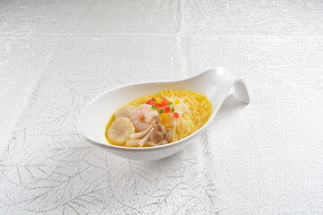 braised cook ramen noodle with scallop seafood, prawn and mushroom in golden chicken stock soup big spoon bowl asian halal menu