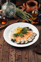 Banquet assorted smoked fish platter on wooden background