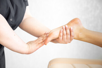 Fototapeta premium A masseur girl does a foot massage. Relax