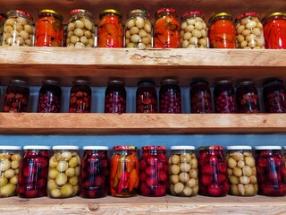 Preserved and fermented food.  Homemade jars with variety of pickled and marinated vegetables, fruit compote.