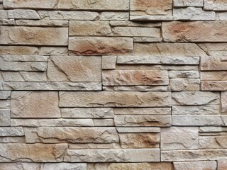 Modern textured grey and yellow stone wall, sandstone slabs background.