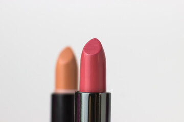 macro. Lipstick close-up pink on a white background