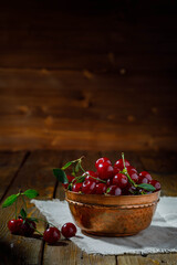 Fresh organic sour cherries on wooden background
