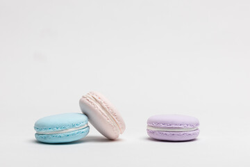 On a table with a white background, there are colorful model macaroons.

