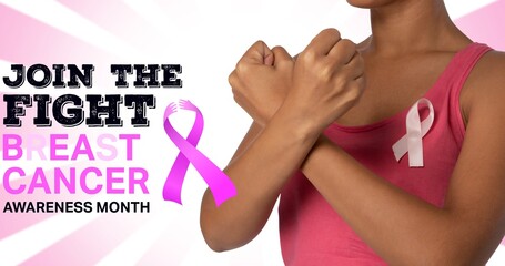 Composition of pink ribbon logo and breast cancer text, with woman crossing fists
