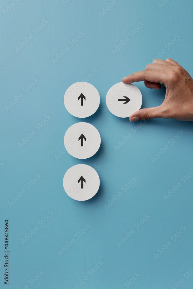 Poster a lot of white arrows are pointing in one direction and one is moving in the other direction. a symb