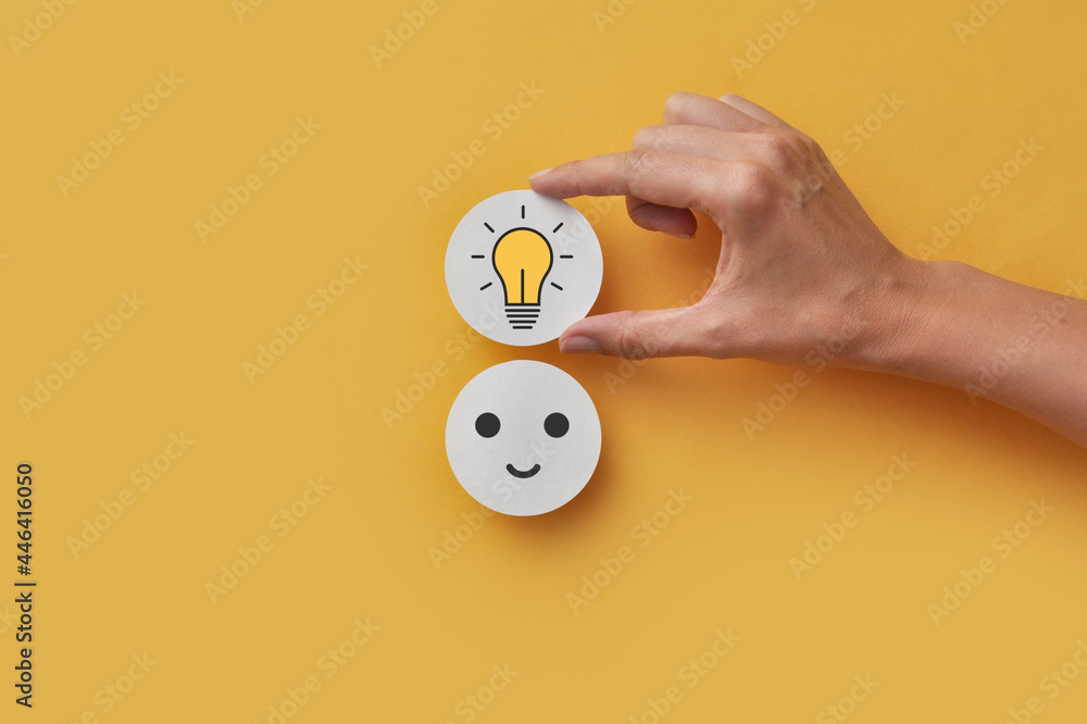 Poster a paper circle with a smile and a light bulb above it. the joy of creating a creative idea and solvi