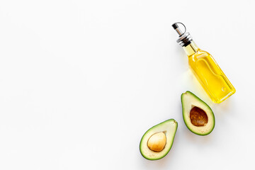 Bottle of avocado essence oil with raw avocado