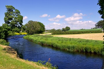 River Doon as it passes through Ayrshire countryside in summer near the village of Dalrymple