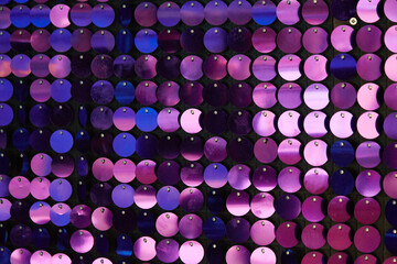shiny texture of the background, a set of round purple sequins sewn on the fabric like fish scales - obrazy, fototapety, plakaty