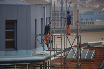Two workers on a scaffold
