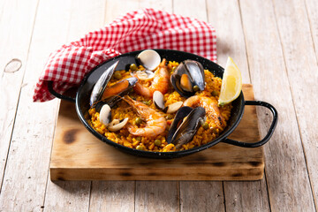 Traditional spanish seafood paella on wooden table