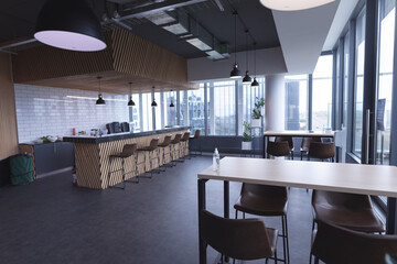 Fototapeta premium Interior of empty cafeteria with tables in modern office