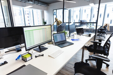 Interior of empty modern office with desks and computers
