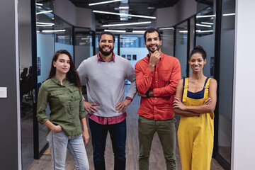 Portrait of diverse group of creative colleagues looking at camera and smiling