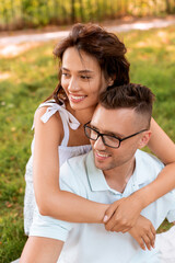Obraz premium leisure, vacation and people concept - happy couple hugging at summer park