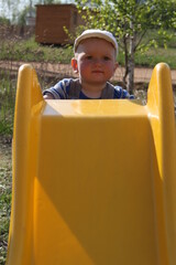 little child boy toddler on playground in summer