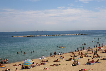 Fototapeta na wymiar Barcelona summer beach landscape with people