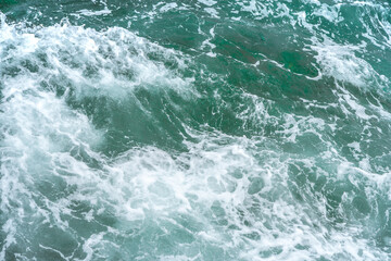 Fototapeta na wymiar Beautiful turquoise ocean waves with rocks