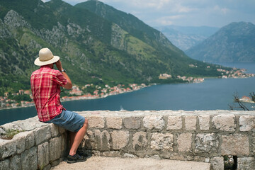 Man makes photos in the beautiful nature landscape, Montenegro.