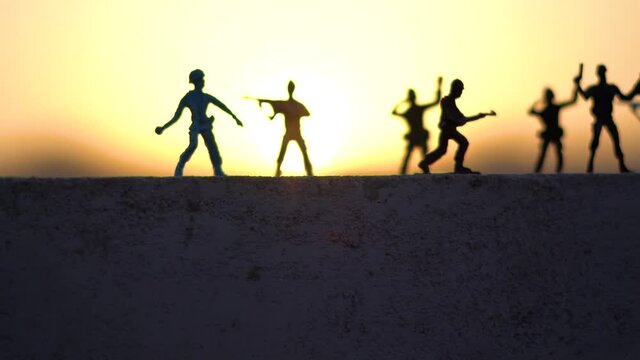 Silhouette shot of toy soldiers in front of the sunset	