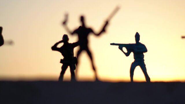 Silhouette shot of toy soldiers in front of the sunset	