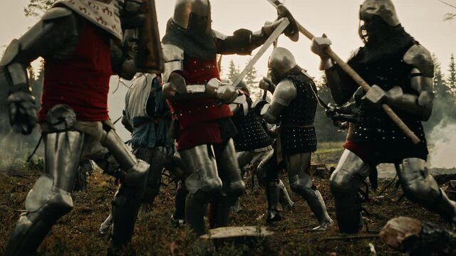 Epic Battlefield: Armies of Medieval Knights Fighting with Swords. Brutal Action Battle of Armored Warrior Soldiers. Dark Ages War, Warfare, Crusade. Cinematic Historical Reenactment. Wide Slow Motion