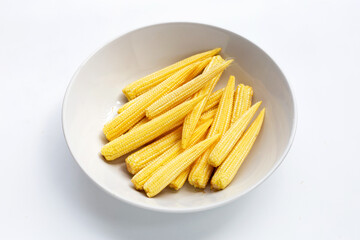 Baby corn in white bowl on white background.