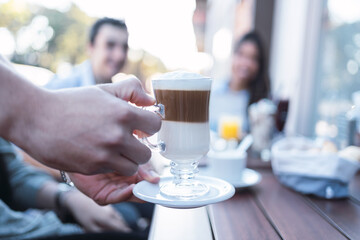 Young couple enjoying a cappuccino in a café.