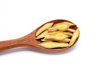 Finger root slices in wooden spoon on white background.