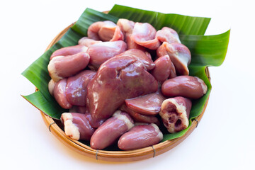 Mixed chicken entrails on banana leaves in bamboo basket on white background.