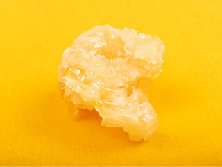 sugar cannabis wax concentrate close up on yellow background