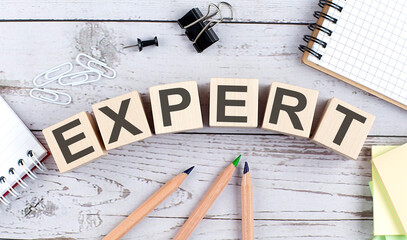 EXPERT text on wooden block with office tools on the wooden background