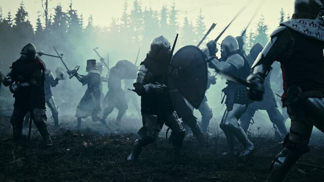 Epic Battlefield: Armies of Medieval Knights Fighting with Swords. Dark Ages Warfare. Action Battle of Armored Warrior Soldiers, Killing Enemies. Blue Cinematic Historical Reenactment. Slow Motion