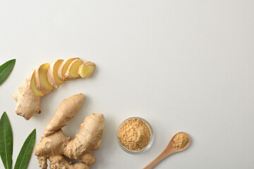 Ginger root and with slices and powder on white table