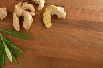 Ginger root as a healing plant with portions on wooden