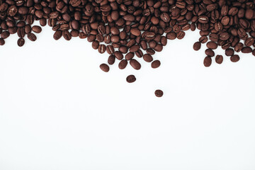 Aromatic dark brown coffee beans isolated on white background. Top view with copy space for your text