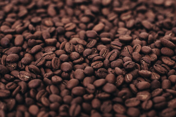 Aromatic dark brown coffee beans background. Top view. Photo with film grain effect