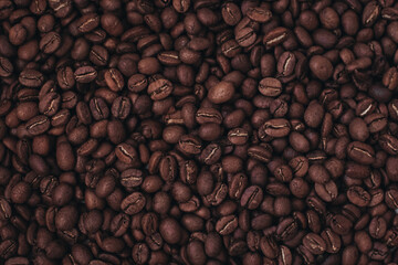 Aromatic brown coffee beans background. Top view. Photo with film grain effect