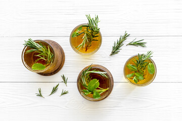 Fefreshing drink of cold tea and rosemary herbs in glasses