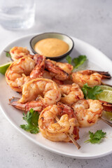 Grilled shrimps. Shrimps skewers, lime and sauce