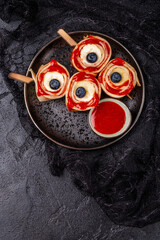 Monster Bloody Eyeballs for Halloween. Crepes roll up with banana and strawberry jam