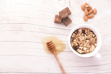  cereal breakfast in bowl, honey, almond and chocolate on white background 