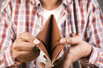 Man hand open an empty wallet with copy space.