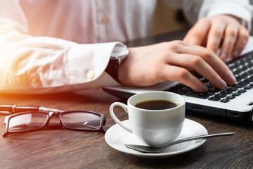 Businessman sitting at desk and using laptop