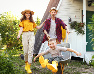 Excited family playing with wheelbarrow