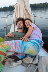 romantic couple lies on a yacht