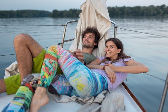 romantic couple lies on a yacht